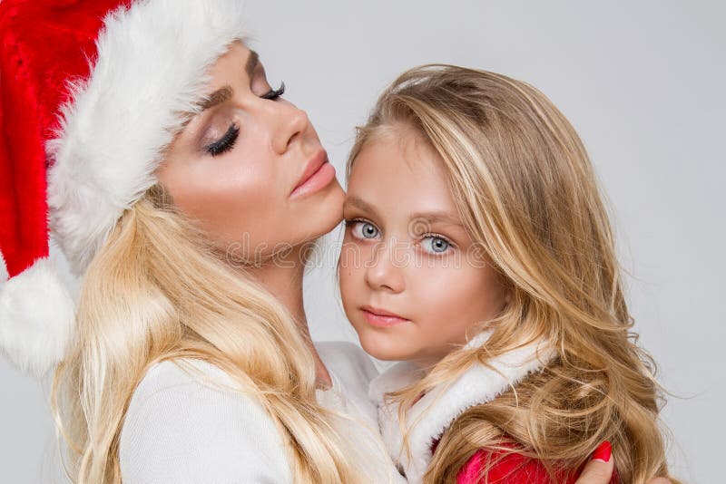 Beautiful Blonde Female Model Mother With Daughter Dressed In A Santa Claus Costume Stock Image