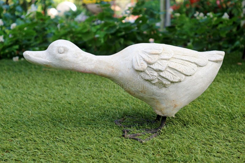 Lovely White Duck Statue Decorated in the Garden stock photos Lovely White Duck Statue Decorated in the Garden stock photos