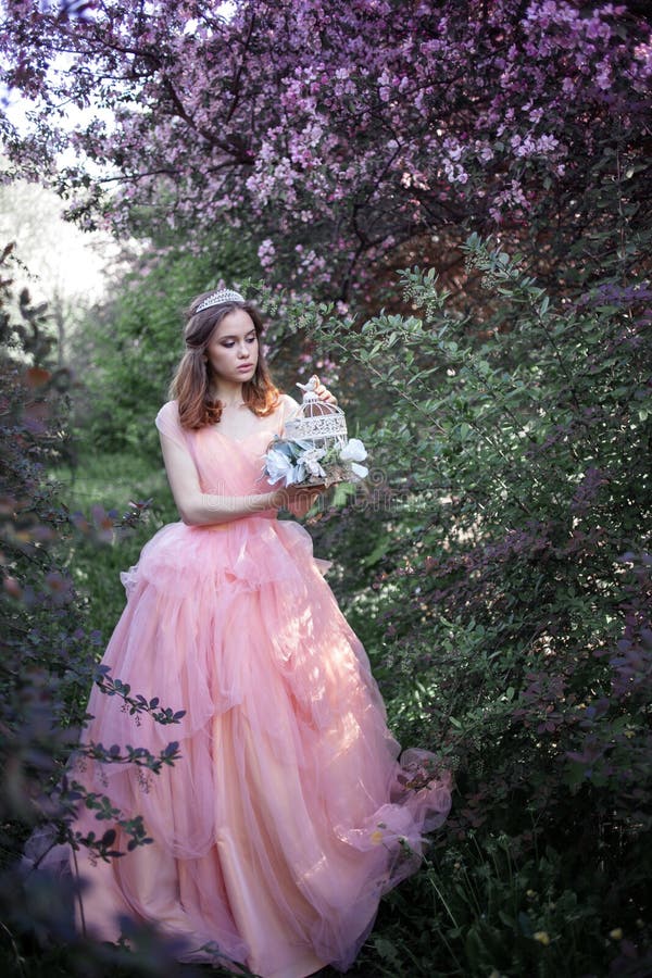 Girl in a Pink Dress in a Flower Garden Stock Photo - Image of ...