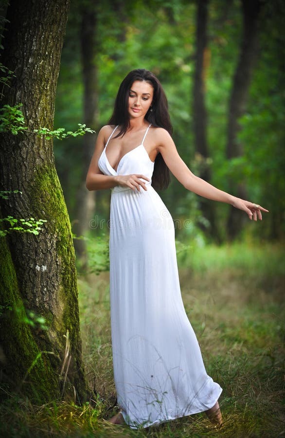 Lovely Young Lady Wearing An Elegant Long White Dress Enjoying The