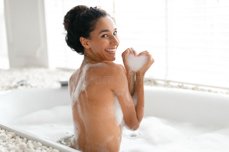 Woman Taking A Bubble Bath At Her Home