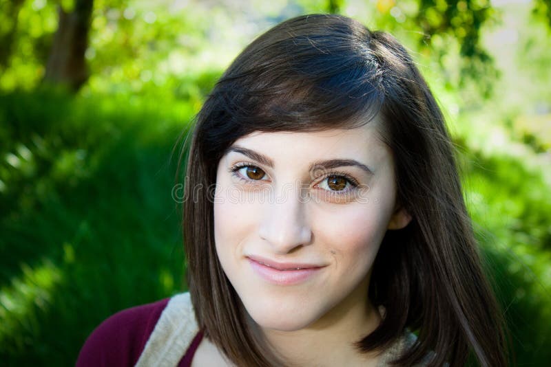 A lovely young women smiling into the camera royalty free stock image