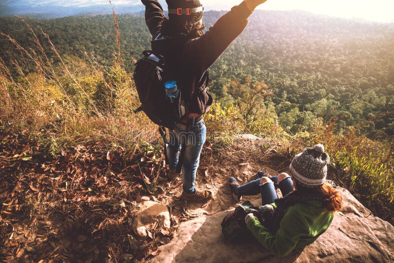 Lover women and men asians travel relax in the holiday. Admire the atmosphere landscape on the Mountain. Mountain Park happily. In stock photography Lover women and men asians travel relax in the holiday. Admire the atmosphere landscape on the Mountain. Mountain Park happily. In stock photography