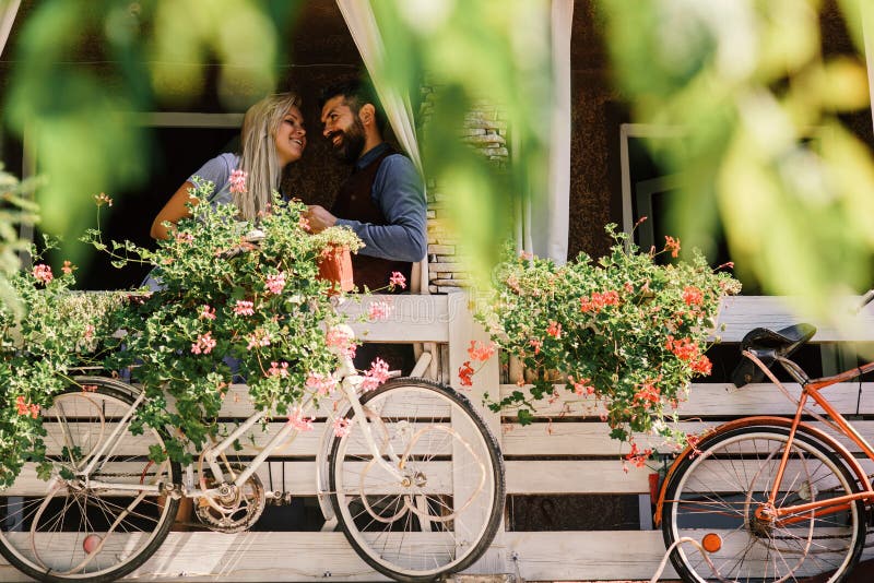 Lovers find place for secret dates. Blonde woman and bearded man happy to see each other.