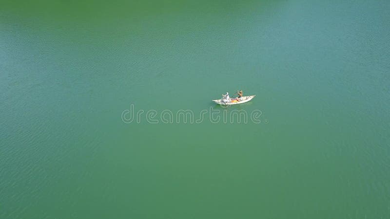 Lovers riding in boat on lake during summer holiday. Happy couple woman and man together relaxing on boat water. People