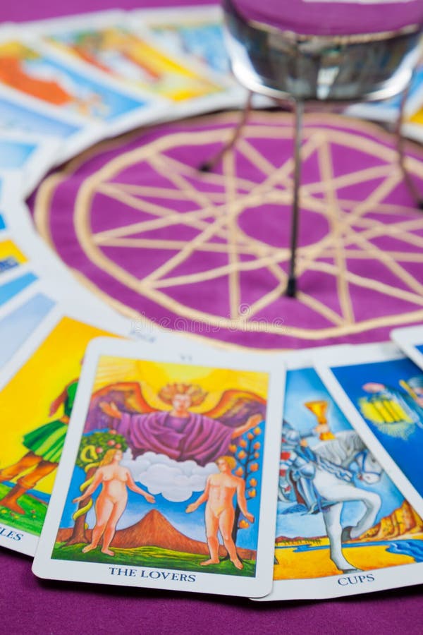 Tarot cards in a circle on a magical pentagram. focus on the card The Lovers. Tarot cards in a circle on a magical pentagram. focus on the card The Lovers.