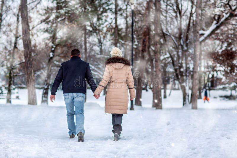 Lovers walking in winter snow- Happy Couple in Winter Park having fun.. royalty free stock photo Lovers walking in winter snow- Happy Couple in Winter Park having fun.. royalty free stock photo