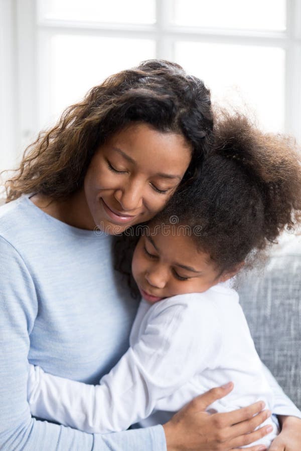 Loving African American Mother Embracing With Daughter