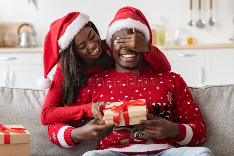 Loving Black Wife Making Surprise for Husband on Christmas Stock Im image
