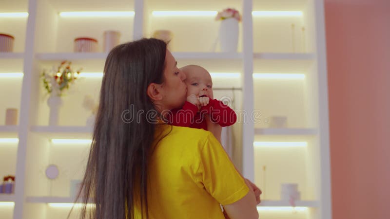 Loving carefree pretty mother and joyful cute infant baby girl bonding at home