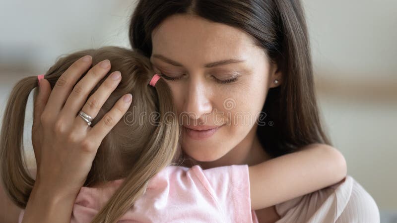 Loving foster parent mom hugging little kid daughter giving comfort