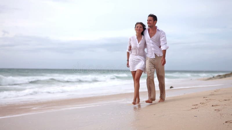 Loving couple on beach in slow motion stock video footage