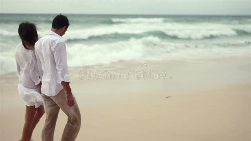 Loving couple on beach in slow motion stock video