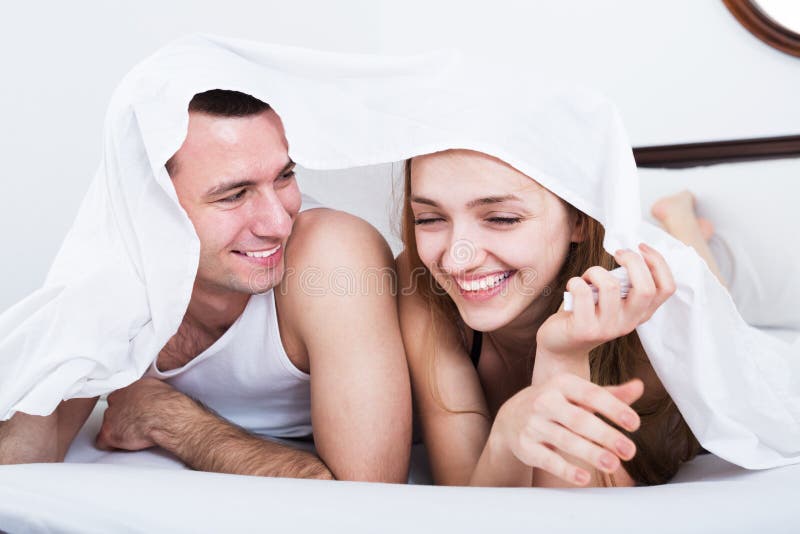 Loving couple hiding under cover stock images Loving couple hiding under cover stock images