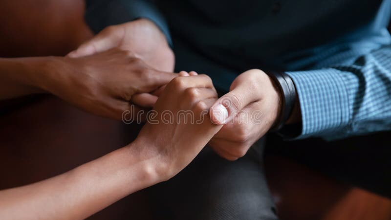 Close up of loving multiracial man and woman hold hands talking meeting in cafe, multiethnic diverse young couple have tender intimate moment, show care support and understanding in relationships. Close up of loving multiracial man and woman hold hands talking meeting in cafe, multiethnic diverse young couple have tender intimate moment, show care support and understanding in relationships