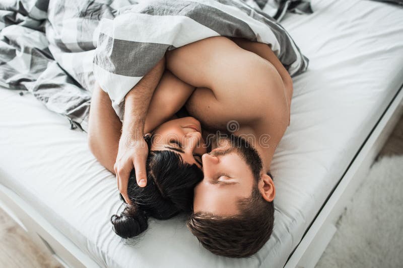 Loving Couple in Bed Having Sex Stock Image