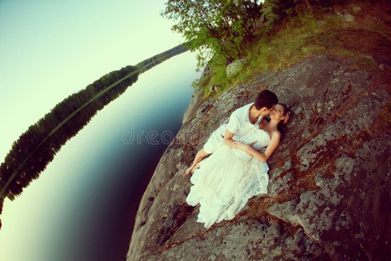Loving couple hugging on the lake. Beauty young woman and man in stock photo Loving couple hugging on the lake. Beauty young woman and man in stock photo