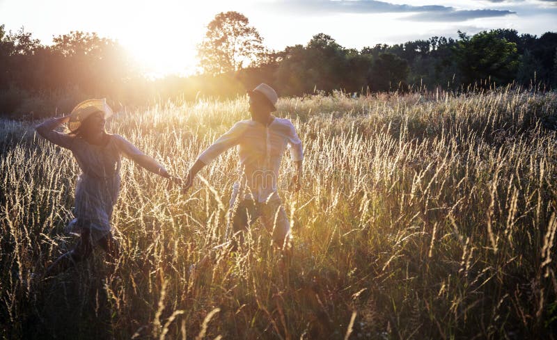 Loving Couple Playing Fool on Grass Field stock photo