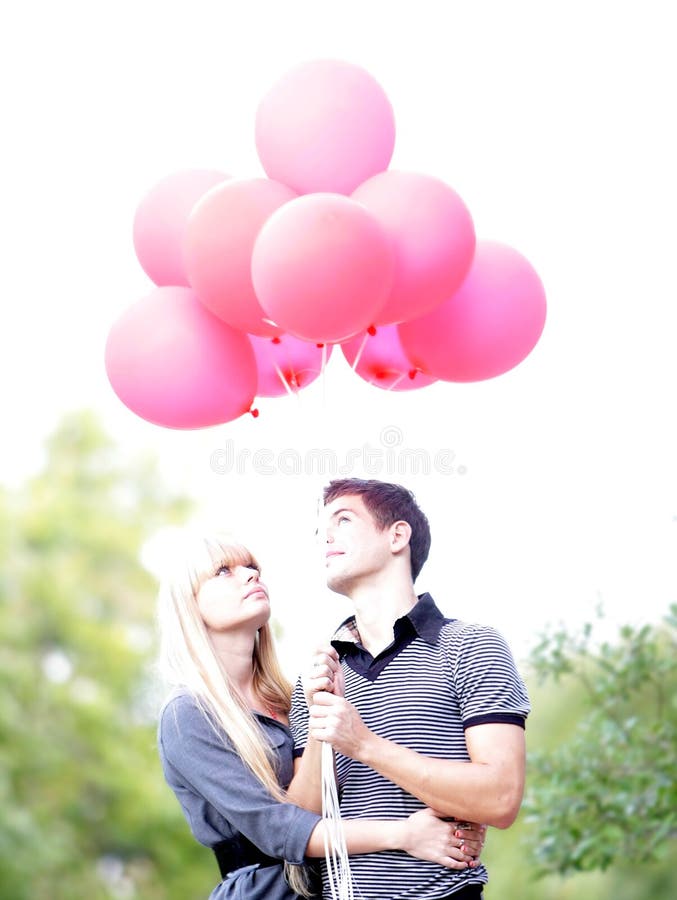 Loving couple with red balloons