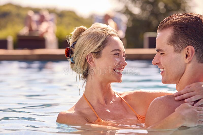 Couple Enjoying Their Holidays In The Pool Stock Photo - Download Image Now  - 20-24 Years, 20-29 Years, 25-29 Years - iStock