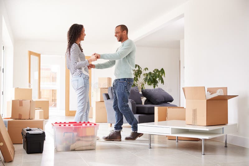 Loving Couple Surrounded By Boxes In New Home On Moving Day royalty free stock photos Loving Couple Surrounded By Boxes In New Home On Moving Day royalty free stock photos