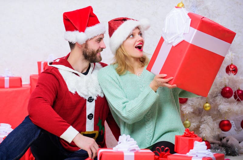 Loving couple unpacking gift christmas tree background. Husband prepared christmas surprise. Couple in love happy enjoy royalty free stock photos Loving couple unpacking gift christmas tree background. Husband prepared christmas surprise. Couple in love happy enjoy royalty free stock photos