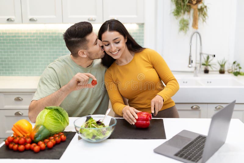 Loving Husband Helping His Beautiful Wife With Cooking Dinner Stock