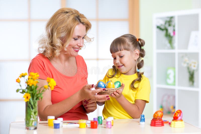Loving mother and her child painting easter eggs stock photography Loving mother and her child painting easter eggs stock photography