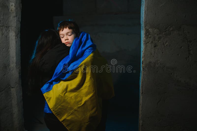 Loving mother holding her child in the bomb shelter. The war in Ukraine. Russia& x27;s aggression