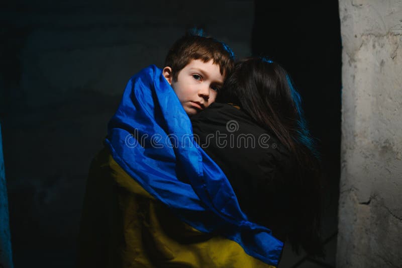 Loving mother holding her child in the bomb shelter. The war in Ukraine. Russia& x27;s aggression