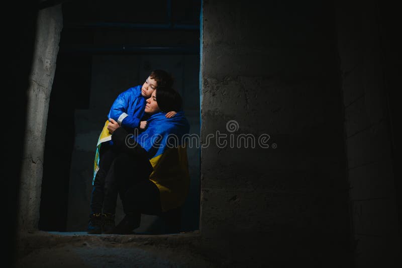 Loving mother holding her child in the bomb shelter. The war in Ukraine. Russia& x27;s aggression