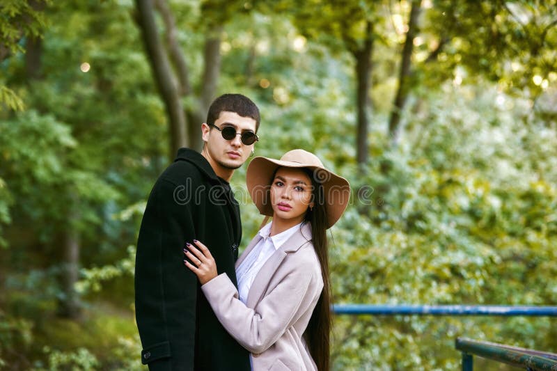 A loving multi-ethnic couple on a walk in the city Park on an autumn day . royalty free stock photography A loving multi-ethnic couple on a walk in the city Park on an autumn day . royalty free stock photography