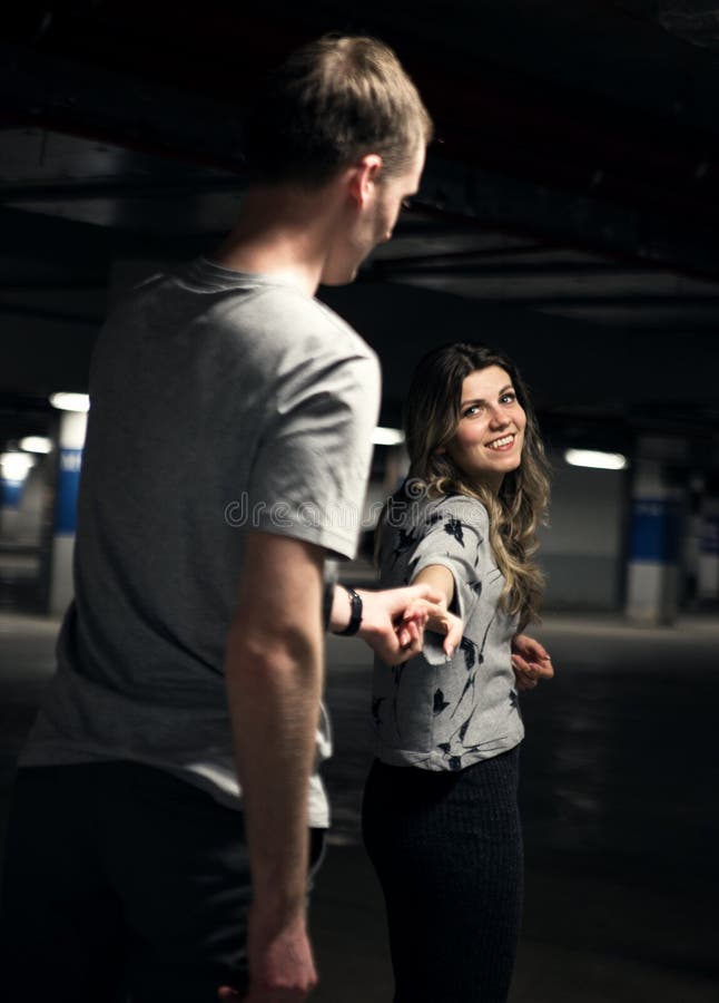 Young couple walking across the parking garage royalty free stock image Young couple walking across the parking garage royalty free stock image