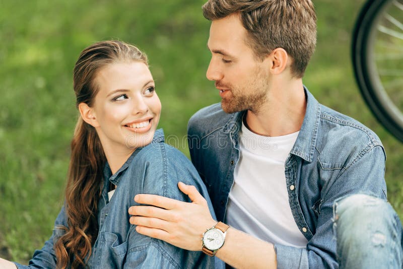loving young couple sitting on grass stock photography loving young couple sitting on grass stock photography