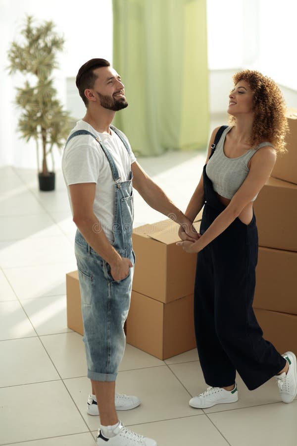 Loving young couple standing in a new apartment
