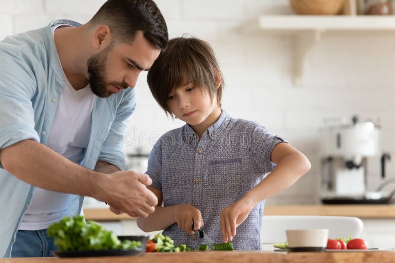 Dad a cook. Заботливый папа на кухне готовит для детей. Dad teaches son how to Cook.