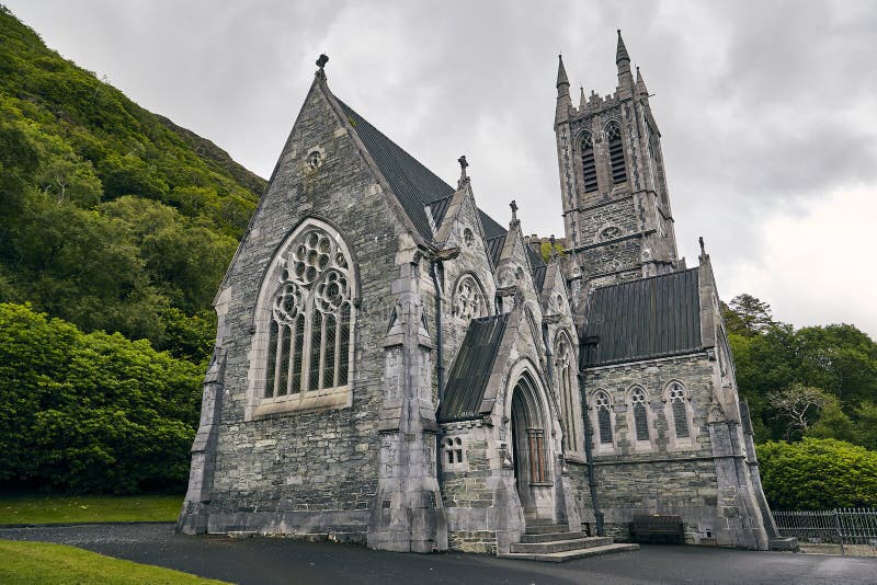 Low angle shot of Kylemore Abbey in Ireland surrounded by greenery royalty free stock photos