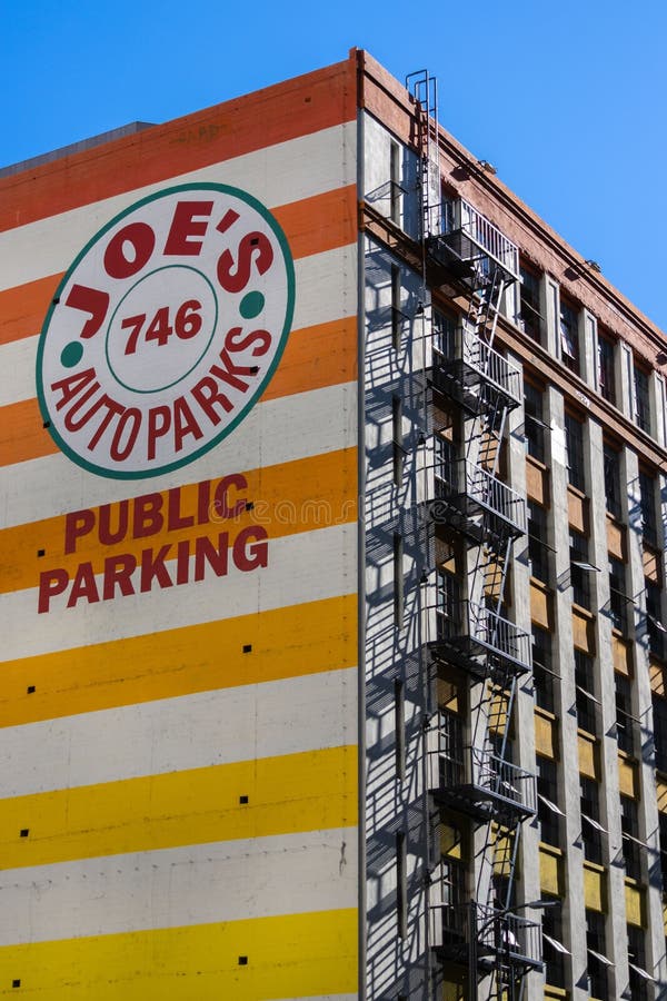 Low angle shot of an orange building with &x22;public parkin&x22; in Los Angeles downtown, California