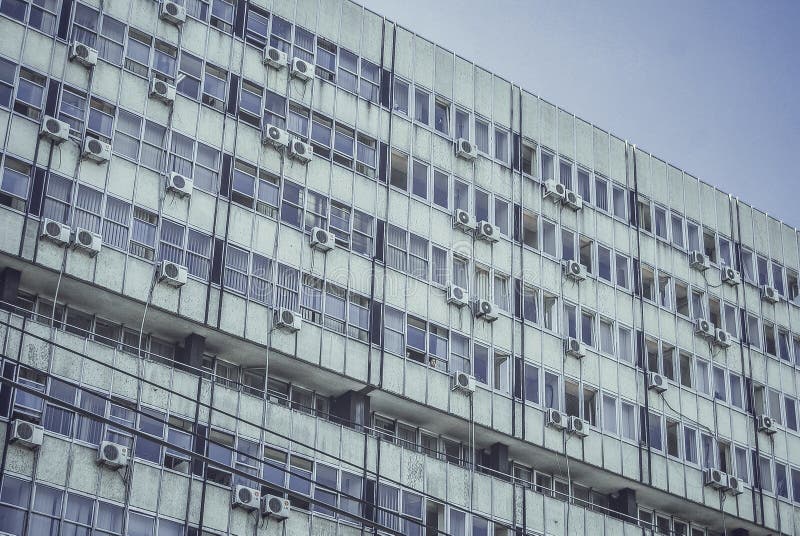 Low angle shot of a white apartment building complex with a blue sky in the background stock image Low angle shot of a white apartment building complex with a blue sky in the background stock image