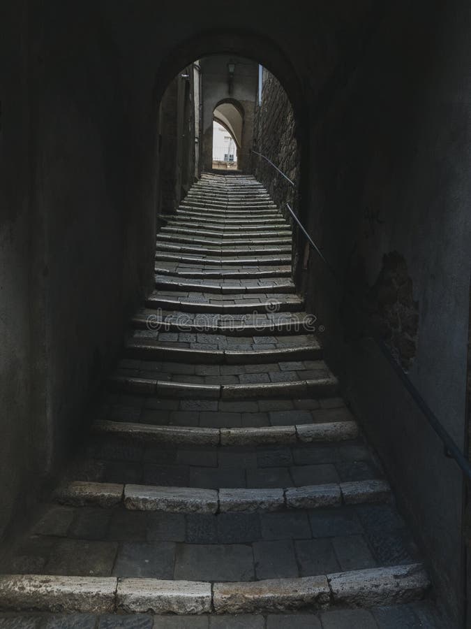 Low angle urban view of tunnel with streets going up to the light in old medieval town from Italy royalty free stock photos Low angle urban view of tunnel with streets going up to the light in old medieval town from Italy royalty free stock photos