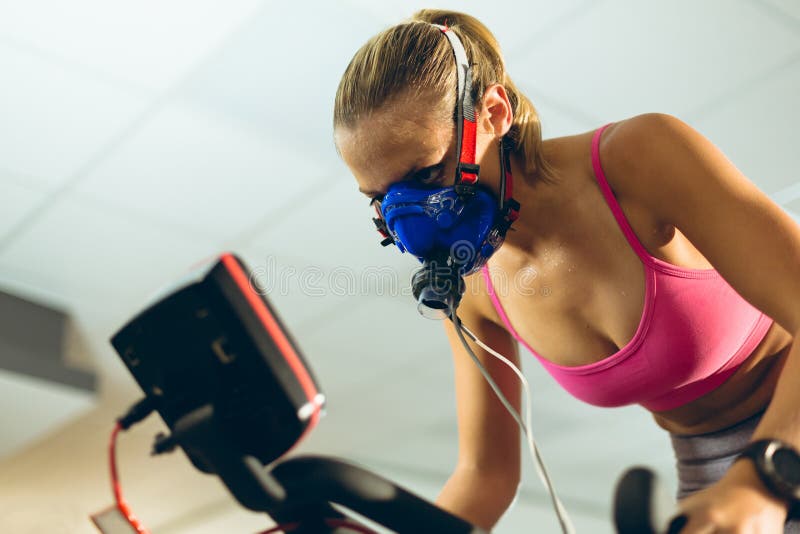 Athlete with Oxygen Mask Exercising Exercise Bike in Fitness Studio Stock Photo - Image of beautiful, 154105554