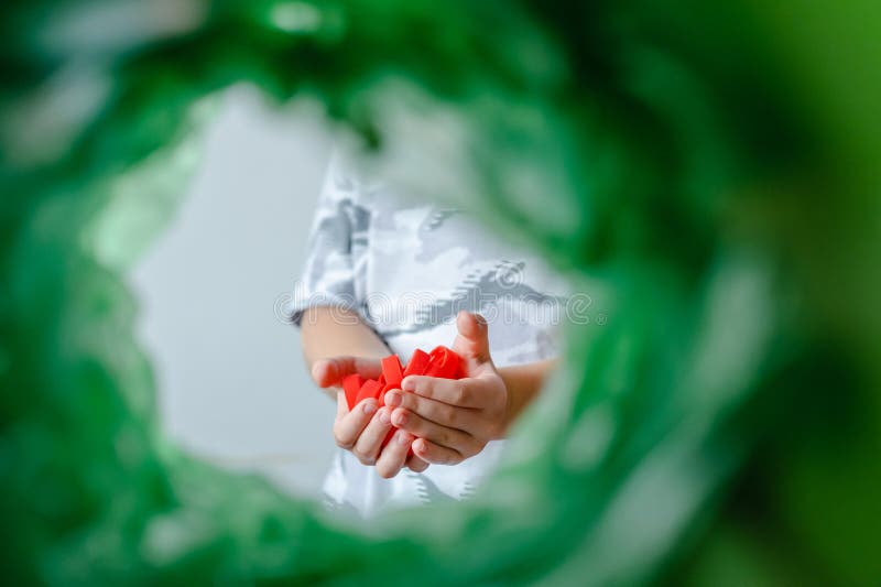 Low angle view child sorting plastic lids products recycling bin POV. Recycling of plastic bottle caps. royalty free stock images
