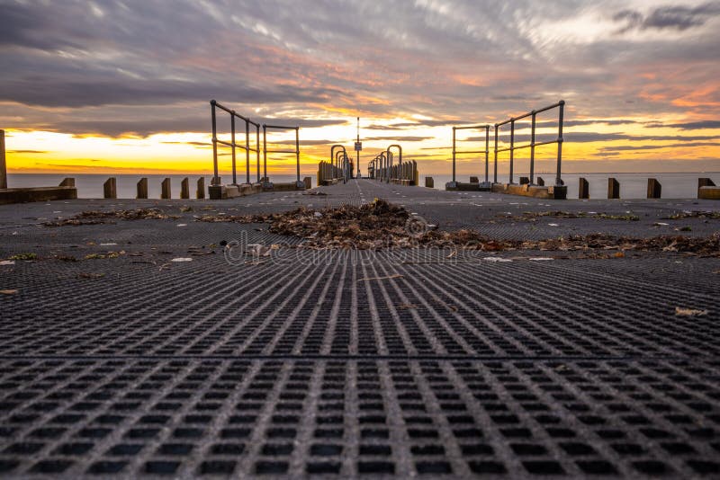 View of debree on boat jetty at sunset. stock photos