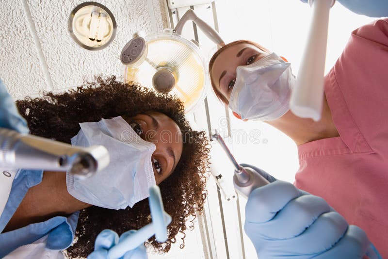 Low angle view of dentist and dental nurse stock photos