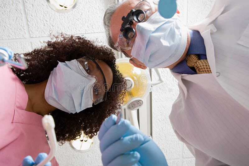 Low angle view of dentist and dental nurse stock photo