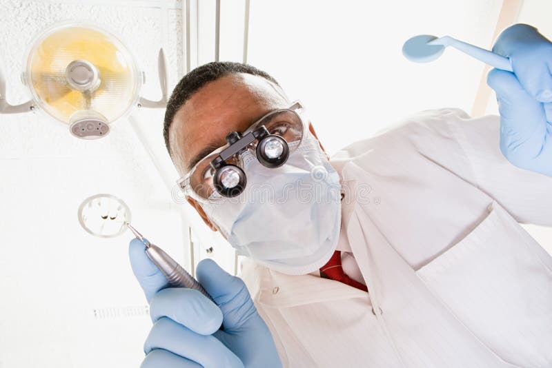 Low angle view of dentist and dental nurse stock photography