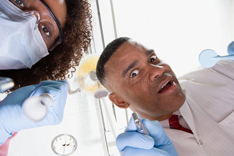 Low angle view of dentist and dental nurse royalty free stock photography
