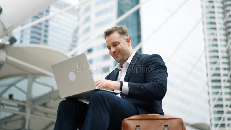 Low angle view of professional business man working on laptop at stairs. Urbane. royalty free stock photo