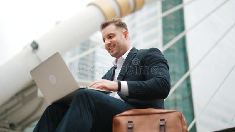 Low angle view of professional business man working on laptop at stairs. Urbane. royalty free stock photo