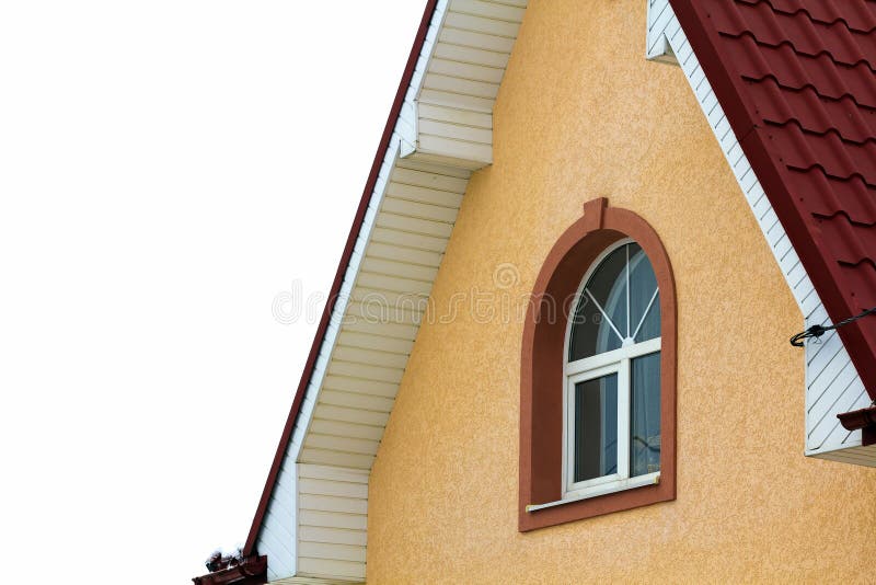 Low angle view of the upper floors of a new large house. Window and roof detail of residential home building. Real estate property